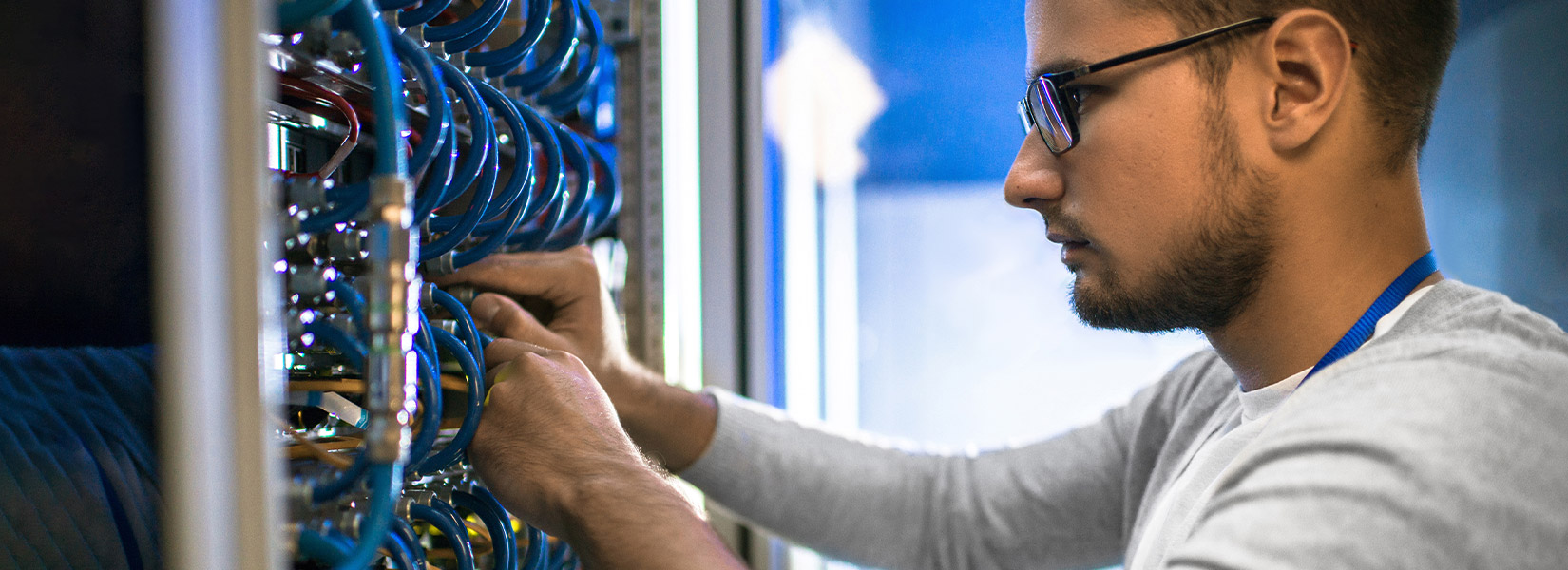 A SONIFI internet network engineer works on wiring at a hotel