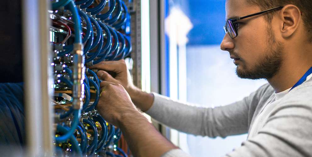 A SONIFI internet network engineer works on backend wiring