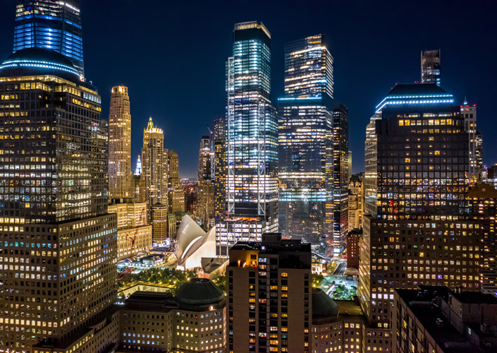 An image of a downtown city with skyscrapers at night